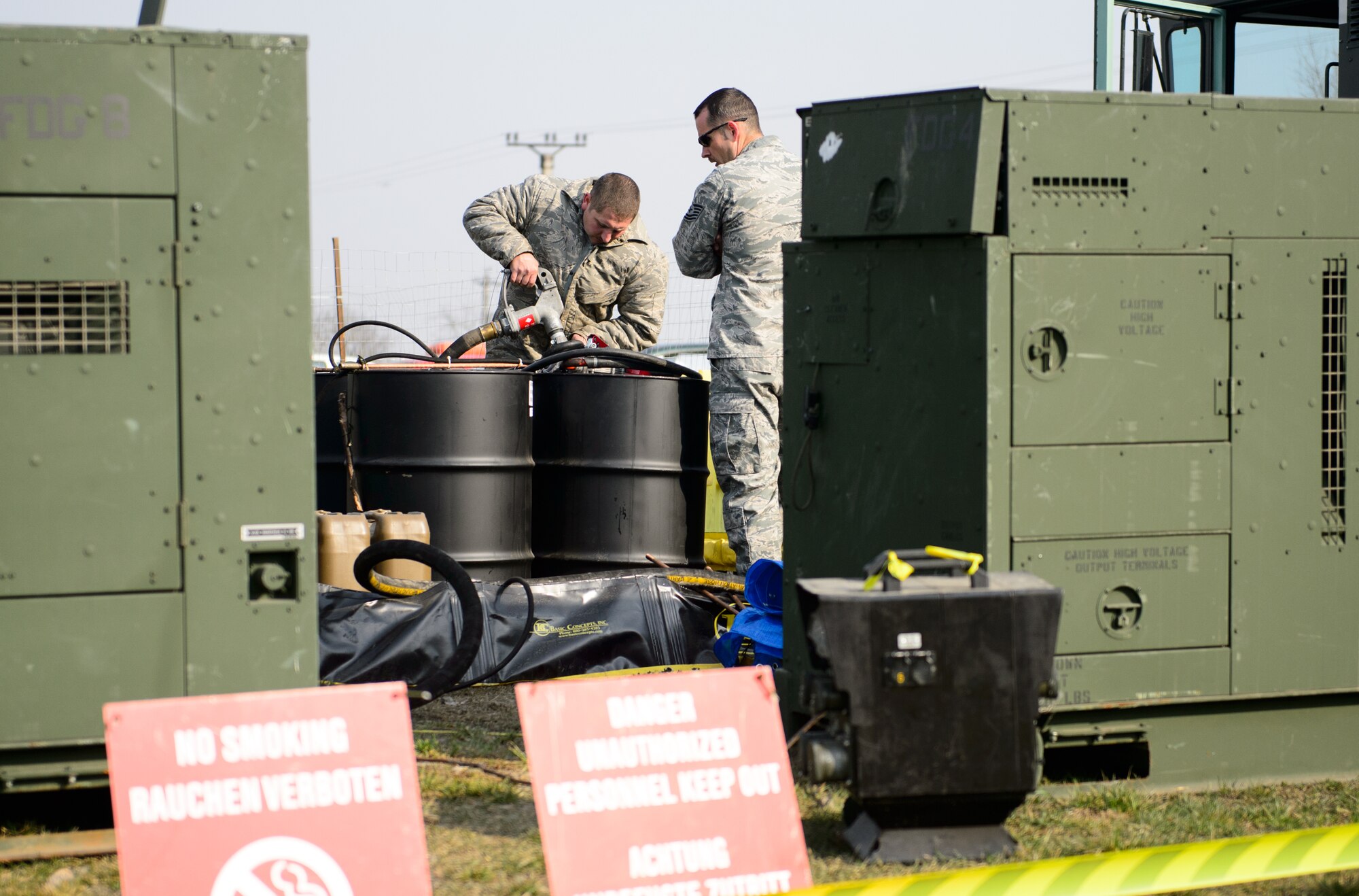 Staff Sgt. Charles Heady, 435th Air Mobility Squadron contingency aerospace ground equipment technician, refuels fuel barrels for the bases generators at Campia Turzii, Romania, March 22, 2015. The 435th Air Ground Operations Wing established a bare base for fighter aircraft from the 52nd Fighter Wing during Dacian Warhawk, a two-week training mission designed to increase the interoperability between U.S. and Romanian air forces. (U.S. Air Force photo/Staff Sgt. Armando A. Schwier-Morales)

