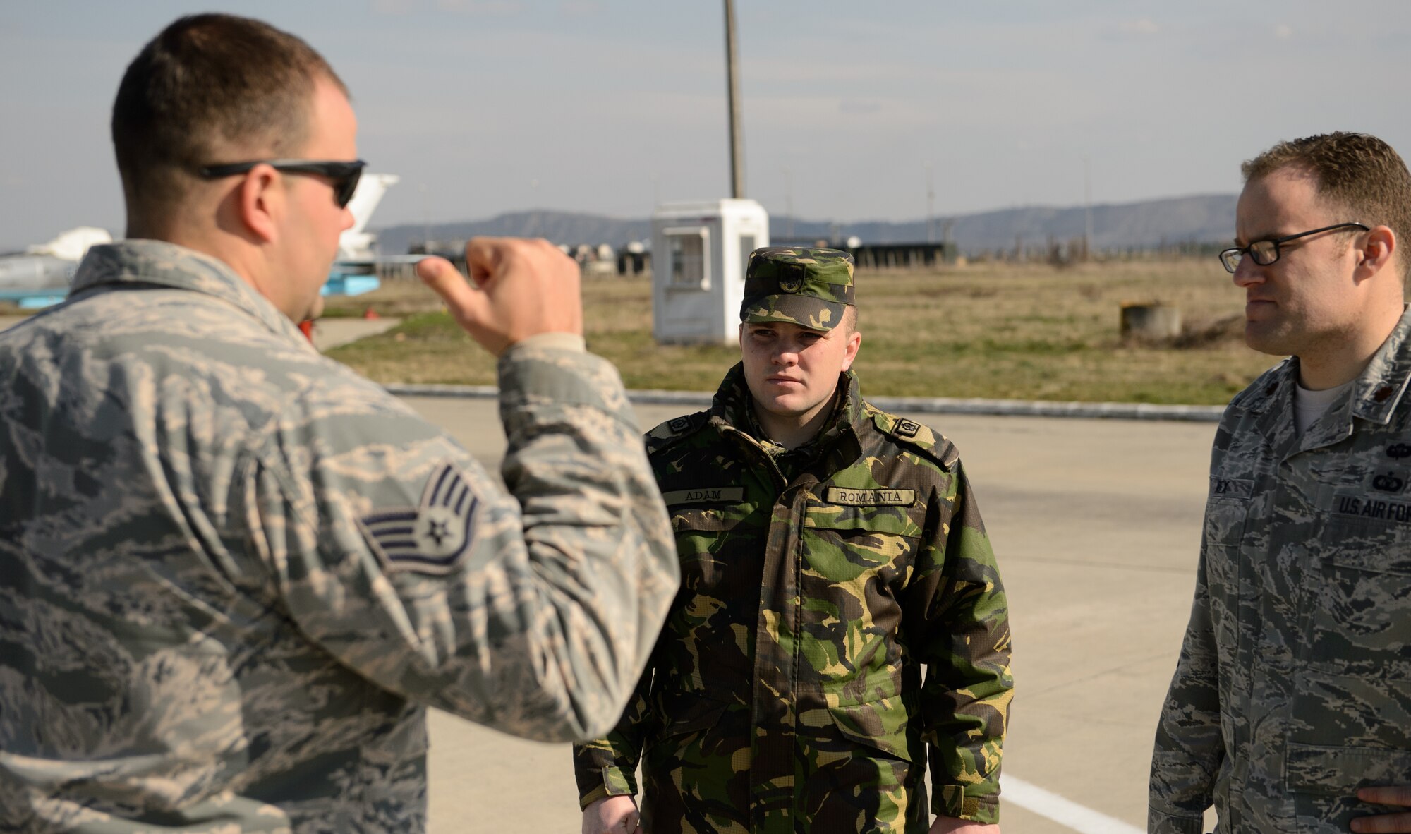 Airmen from the U.S. and Romanian air forces discuss ways to improve the flightline at Campia Turzii, Romania, March 18, 2015. The Airmen are part of the training event Dacian Warhawk, designed to improve expertise and increase interoperability. (U.S. Air Force photo/Staff Sgt. Armando A. Schwier-Morales)