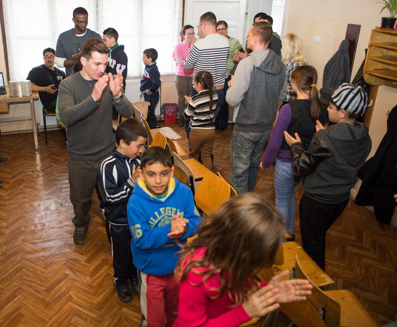 Airmen from the 435th Air Ground Operations Wing play games with children at a local community center at Campia Turzii, March 20, 2015. The Airmen visited the center for less-than-fortunate children from the local area to bring gifts, teach English and play games with more than 50 children attending an after school education program. (U.S. Air Force photo/Staff Sgt. Armando A. Schwier-Morales)