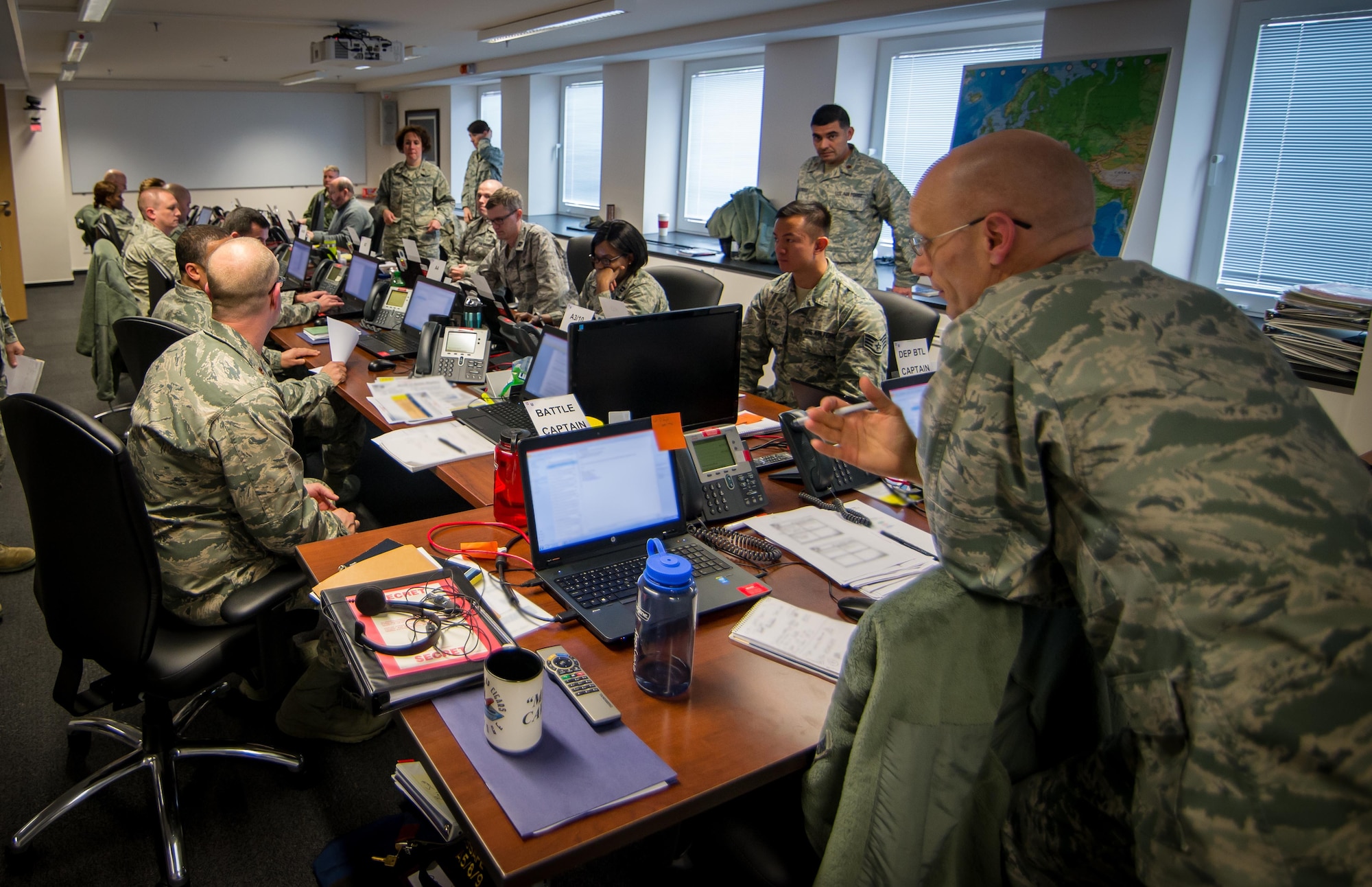 The U.S. Air Forces in Europe and Air Forces Africa battle staff monitors events during a large-scale defense exercise that consists of computer-based command post simulations to test Airmen assigned to the headquarters on Ramstein Air Base, Germany, March 22, 2015. The scenarios selected for Exercise Austere Challenge & Judicious Response 2015 are designed to train our forces to face any situation. (U.S. Air Force photo/ Staff Sgt. Ryan Crane/Sensitive information blurred using photo editing software)