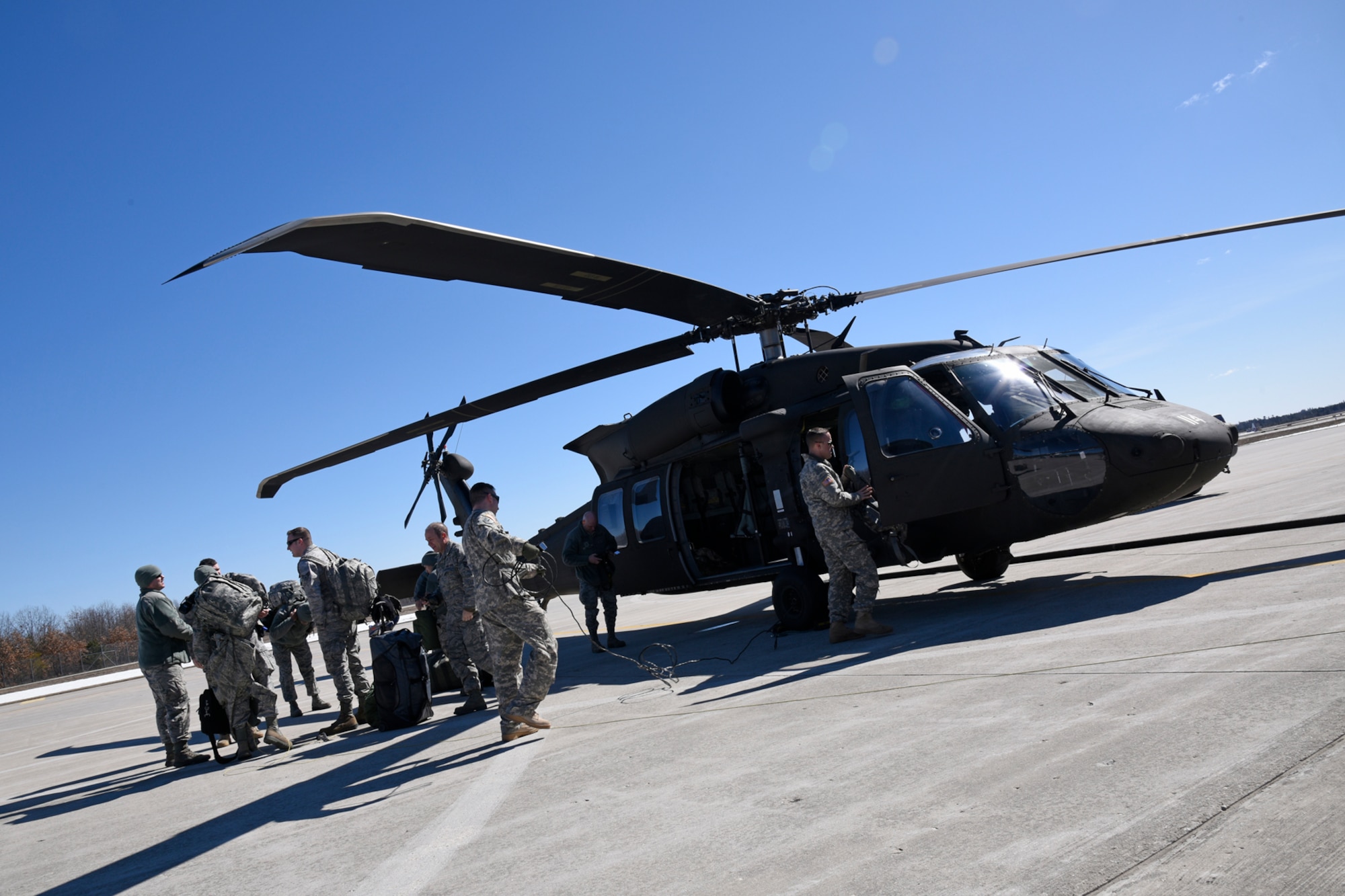 Members of the 127th Logistics Readiness Squadron board a UH-60 Black Hawk on the flight line at Selfridge Air National Guard Base, Mich., March 18, 2015. The 127th LRS team is temporarily relocating to support a mobilization exercise of the Michigan Army National Guard’s 119th Field Artillery. (U.S. Air National Guard photo by Senior Airman Ryan Zeski/Released)