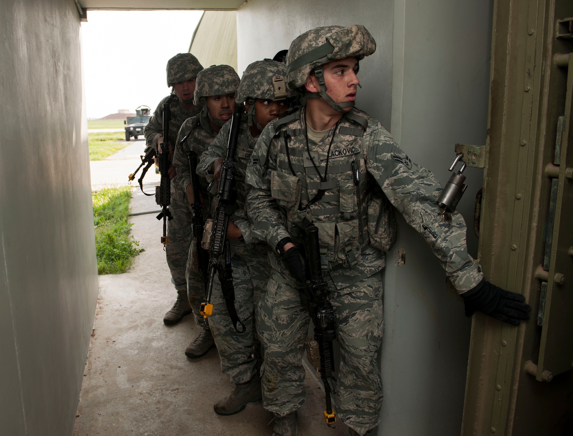 Airmen from the 39th Security Forces Squadron, prepare to tactically enter a protective aircraft shelter March 18, 2015, at Incirlik Air Base, Turkey. The Airmen responded to a simulated attack from inside the shelter as part of an exercise to complete one of their annual training requirements. (U.S. Air Force photo by Senior Airman Krystal Ardrey/Released)