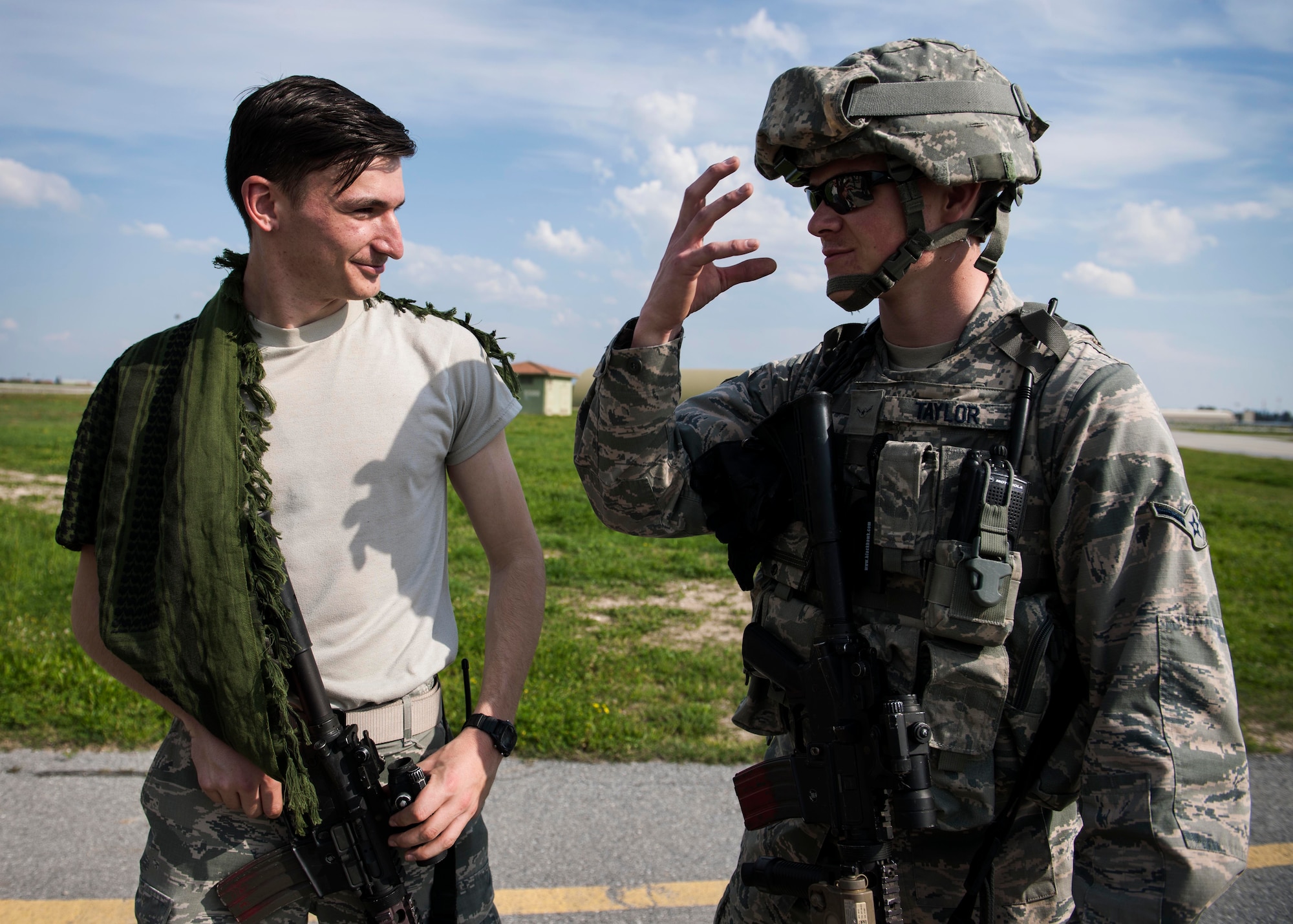 Airman 1st Class Michael Schantz and Airman Jason Taylor, 39th Security Forces Squadron response team members, discuss tactics during a force-on-force training March 18, 2015, at Incirlik Air Base, Turkey. Schantz volunteered to act as a member of an opposing force and Taylor is participating in the exercise to fulfill his annual training requirements. (U.S. Air Force photo by Senior Airman Krystal Ardrey/Released)