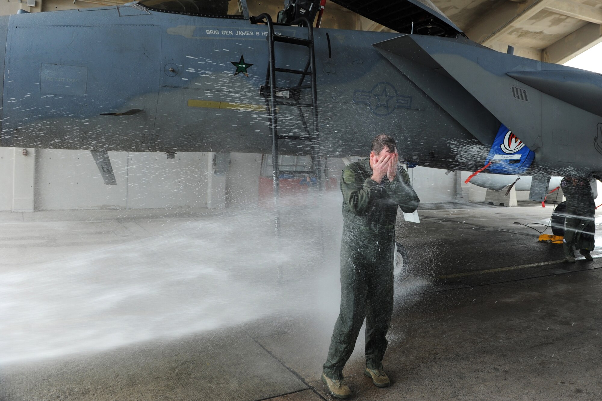 U.S. Air Force Brig. Gen. James B. Hecker gets hosed down after his final flight as 18th Wing commander at Kaden Air Base, Japan, March 24, 2015. Military aviators have a tradition where aircrew members, upon completion of their final flight, or "fini flight," are met and hosed down by their squadron comrades, family and friends. (U.S. Air Force photo by Airman 1st Class Stephen G. Eigel)