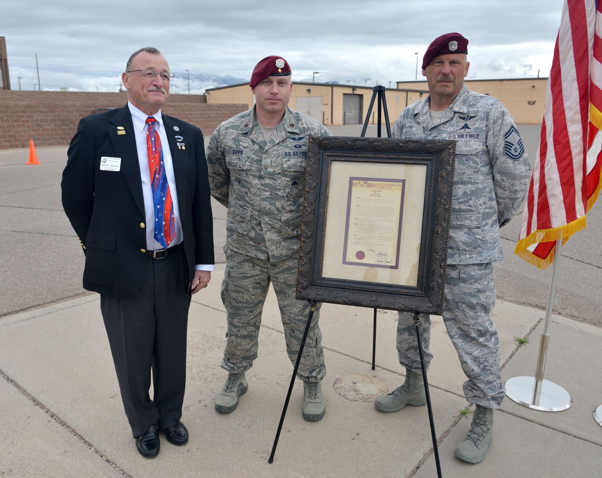 Roger Newell (left), Albuquerque’s liason for veterans, Maj. Seth Davis, 342nd Training Squadron commander, and Senior Master Sgt. Robert Bean, commandant of the Pararescue and Combat Rescue School, stand next to a proclamation at the Drug Enforcement Agency Maltz Challenge at Kirtland Air Force Base, New Mexico, March 20, 2015. The document, signed by Albuquerque Mayor Richard Berry, proclaims March 23 as "PJ Day." The competition honored fallen pararescueman Master Sgt. Michael Maltz, as well as Albuquerque native Army Pfc. Zachary Lovejoy, an Army paratrooper killed in 2010 in Afghanistan. (U.S. Air Force photo by Todd Berenger)