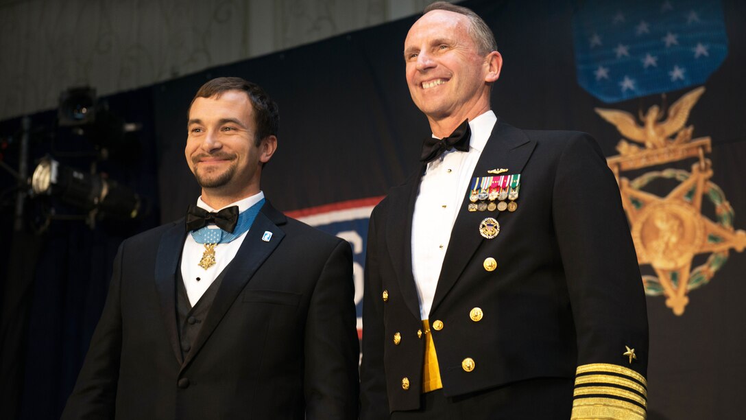 Navy Adm. Jonathan W. Greenert, chief of naval operations, poses for a photograph with former Army Staff Sgt. Salvatore Giunta, who received a Medal of Honor for bravery while serving in Afghanistan, during the USO of Metropolitan Washington-Baltimore's 33rd annual awards dinner in Arlington, Va., March 24, 2015.