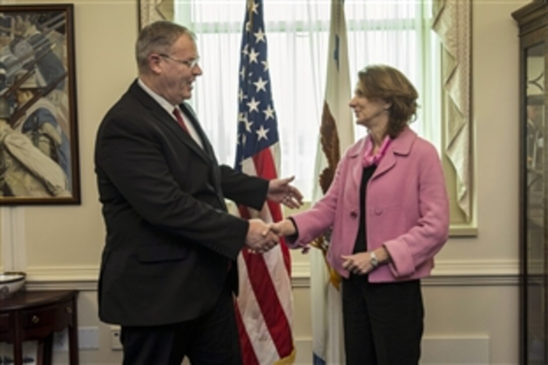 U.S. Deputy Defense Secretary Bob Work welcomes Montenegro Defense Minister Milica Pejanovic-Djurisic to the Pentagon, March 25, 2015, to discuss matters of mutual importance.