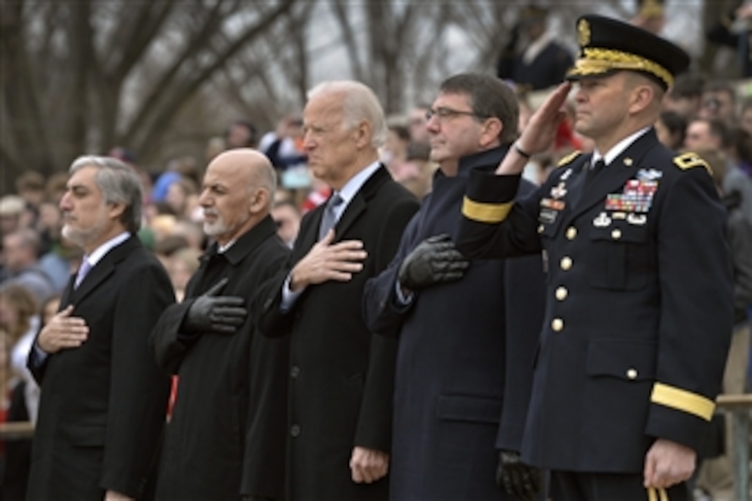 U.S. Defense Secretary Ash Carter, second from right, with, from left, Afghan Chief Executive Abdullah Abdullah, Afghan President Ashraf Ghani and Vice President Joe Biden participate in a wreath-laying ceremony at the Tomb of the Unknown Soldier at Arlington National Cemetery in Arlington, Va., March 24, 2015. 