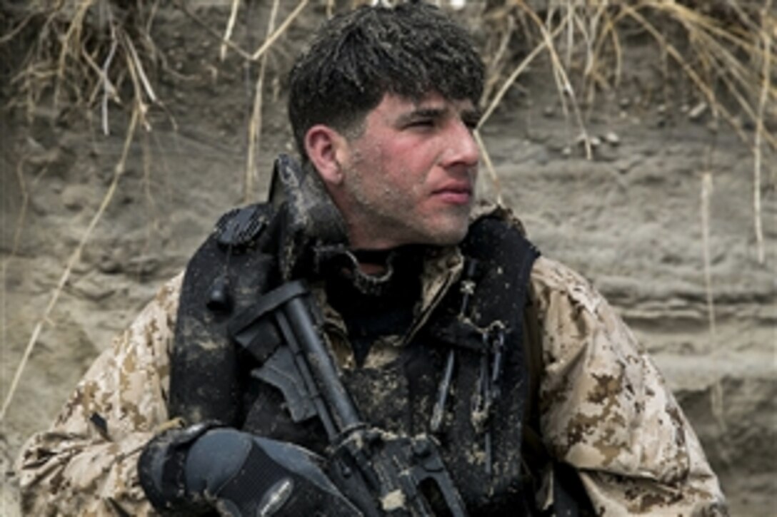 Marine Cpl David Elliot observes the beach during an amphibious beach exercise on Camp Lejeune, N.C., March 20, 2015.  Elliot is assigned to 2nd Reconnaissance Battalion, 2nd Marine Division. 