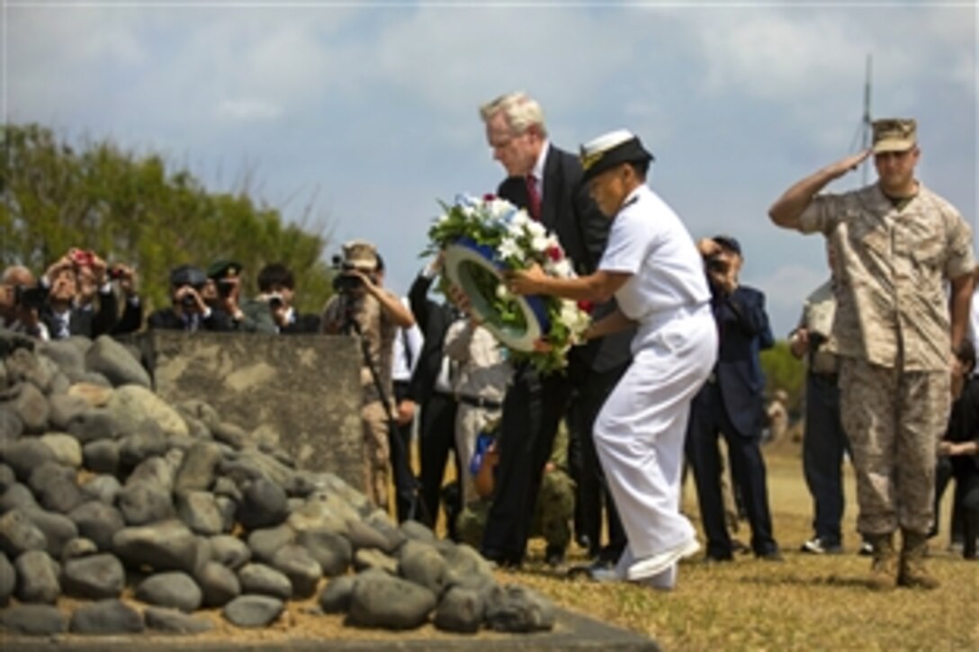 U.S. Navy Secretary Ray Mabus, left, places a flower wreath at the base of the Reunion of Honor monument during the 70th anniversary of the Battle of Iwo Jima at the Reunion of Honor memorial in Iwo To, Japan, March 21, 2015. U.S. and Japanese veterans and their families, U.S. Marines and sailors assigned to the 3rd Marine Expeditionary Force and leaders from both nations attended the event.