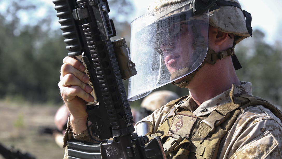 Lance Cpl. Jordan W. Kingston, a rifleman with Golf Co., 2nd Battalion, 6th Marines, reloads his M203 grenade launcher during a non-lethal weapons training exercise aboard Camp Lejeune, N.C., March 24, 2015. The Marines fired 40 mm sponge grenades at dummy targets down range, to familiarize the unit with non-lethal weapons.