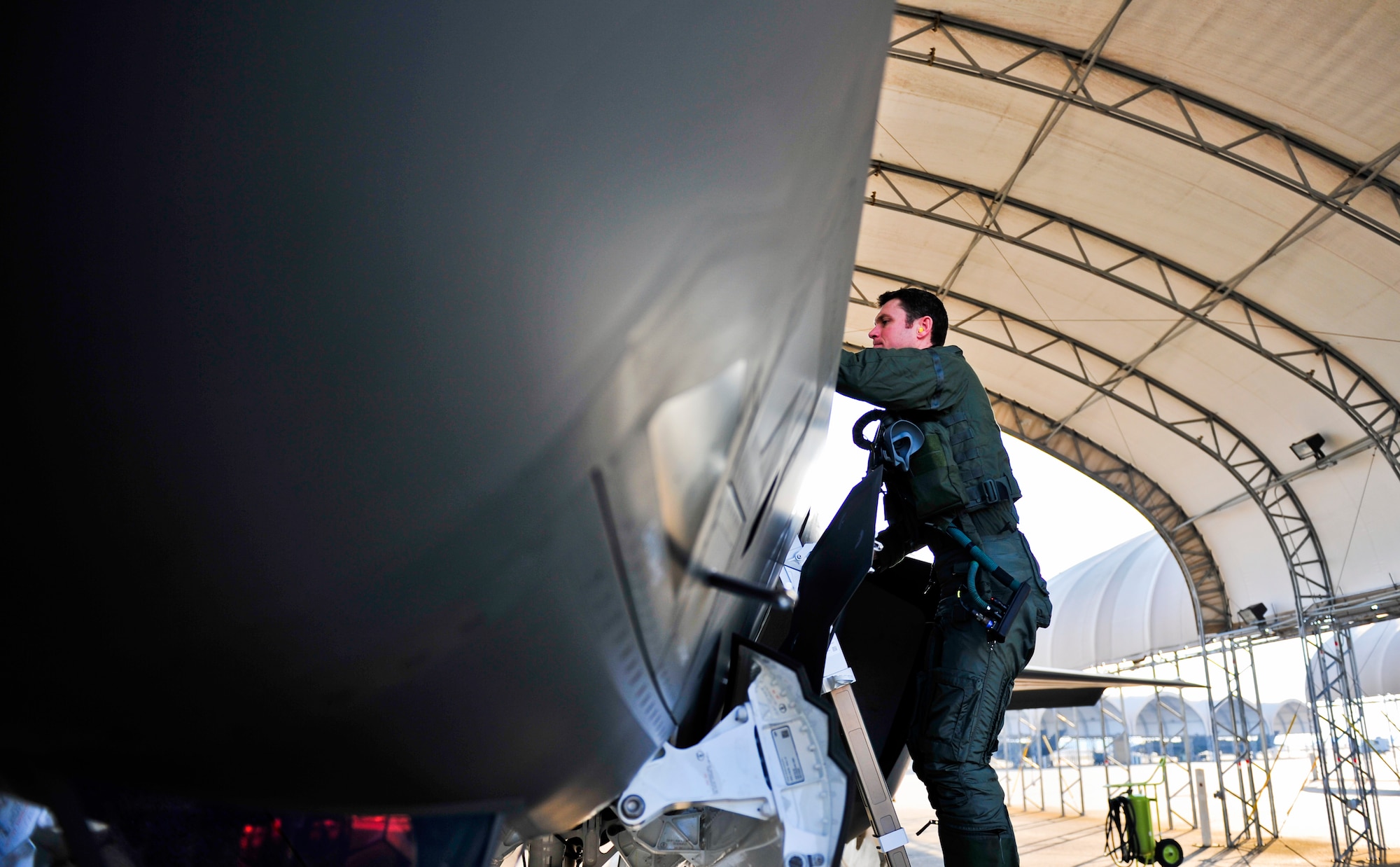 Royal Australian Air Force Squadron Leader Andrew Jackson, F-35 Lightning II student pilot, climbs into an F-35A before his first flight on Eglin Air Force Base, Fla., March 18, 2015. Jackson arrived in the United States in December 2014 and started his training at the F-35 Academic Training Center on Jan. 26, Australia Day. Since then, Jackson has completed 154 classroom hours and 64 hours throughout 16 flight simulations, before stepping to his first aircraft. (U.S. Air Force photo/Staff Sgt. Marleah Robertson)