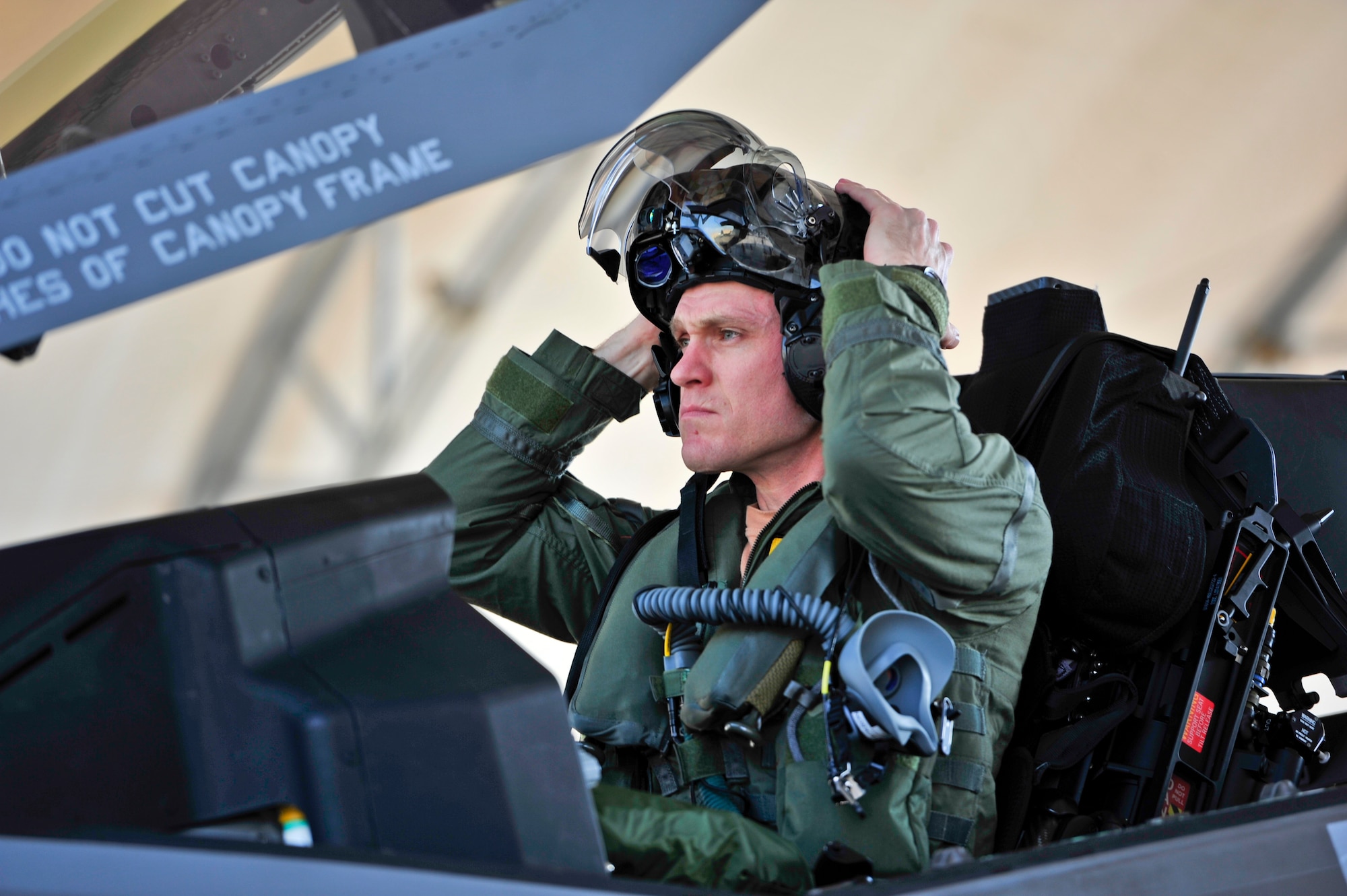 Royal Australian Air Force Squadron Leader Andrew Jackson, F-35 Lightning II student pilot, puts on his helmet before his first flight in an F-35A on Eglin Air Force Base, Fla., March 18, 2015. Jackson made history as the first Australian pilot to fly in the F-35A. The fifth-generation aircraft will meet Australia’s future air combat and strike needs, providing a networked force-multiplier effect in terms of situational awareness and combat effectiveness. (U.S. Air Force photo/Staff Sgt. Marleah Robertson)