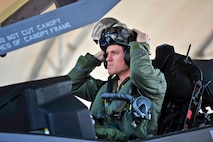 Royal Australian Air Force Squadron Leader Andrew Jackson, F-35 Lightning II student pilot, puts on his helmet before his first flight in an F-35A on Eglin Air Force Base, Fla., March 18, 2015. Jackson made history as the first Australian pilot to fly in the F-35A. The fifth-generation aircraft will meet Australia’s future air combat and strike needs, providing a networked force-multiplier effect in terms of situational awareness and combat effectiveness. (U.S. Air Force photo/Staff Sgt. Marleah Robertson)