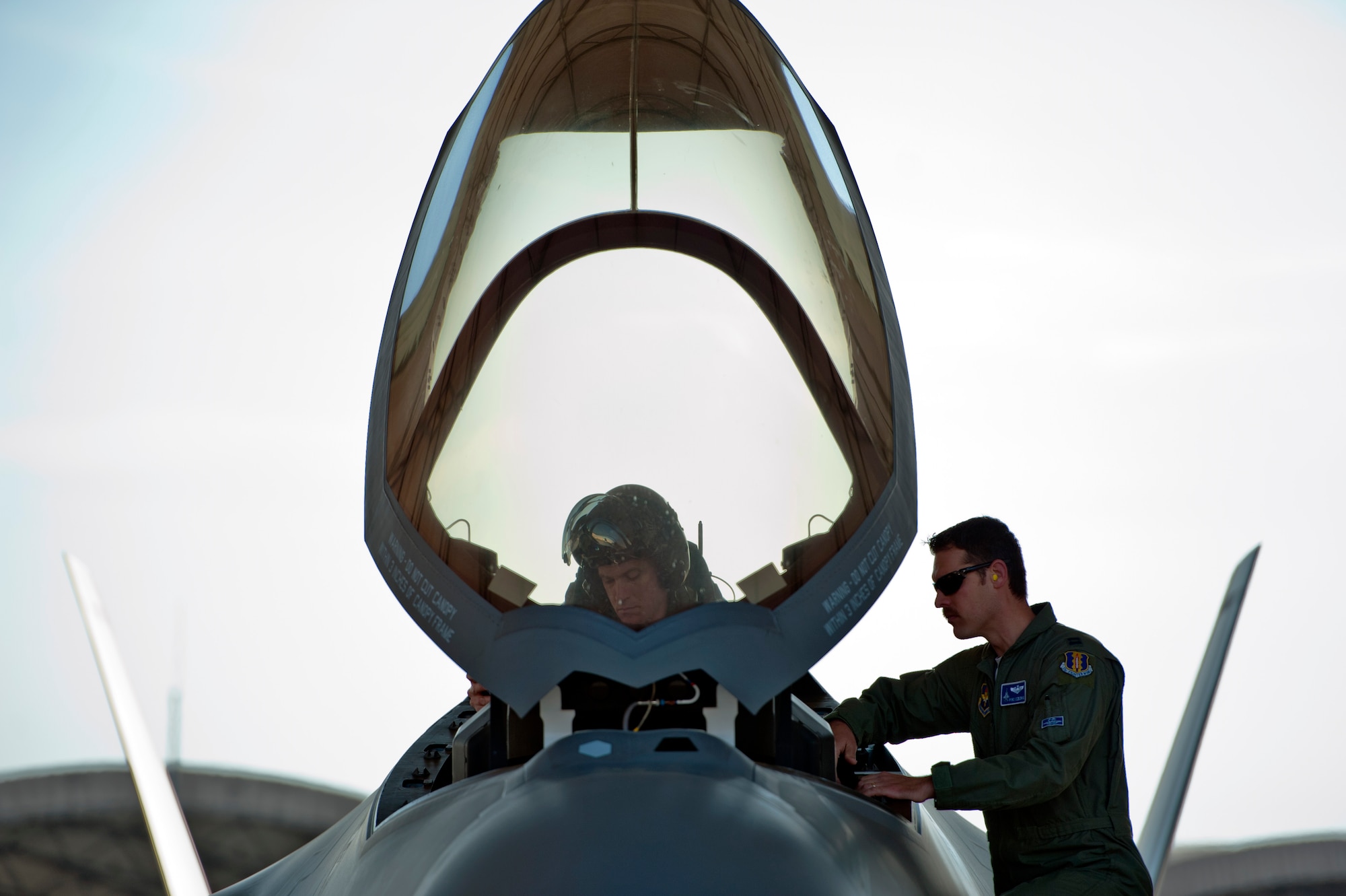 Royal Australian Air Force Squadron Leader Andrew Jackson, F-35 Lightning II student pilot, prepares for his first flight in an F-35A under the supervision of Capt. Jeffrey Osborne, 58th Fighter Squadron F-35 pilot and chief of standardization and evaluation, on Eglin Air Force Base, Fla., March 18, 2015. Jackson arrived in the United States in December 2014 and started his training at the F-35 Academic Training Center on Jan. 26, Australia Day. Since then, Jackson has completed 154 classroom hours and 64 hours throughout 16 flight simulations, before stepping to his first aircraft. (U.S. Air Force photo/Staff Sgt. Marleah Robertson)