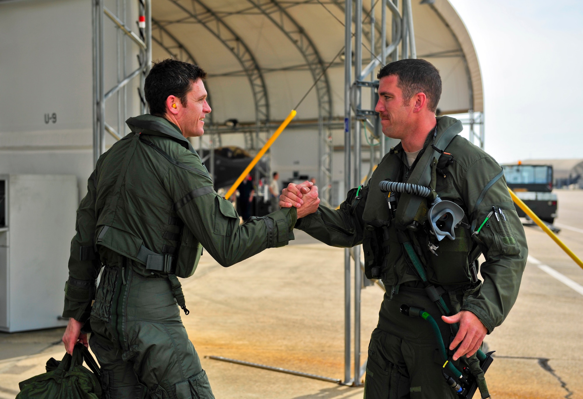 Royal Australian Air Force Squadron Leader Andrew Jackson, F-35 Lightning II student pilot, left, is congratulated by Lt. Col. Matthew Renbarger, 58th Fighter Squadron commander, after completing his first flight on Eglin Air Force Base, Fla., March 18, 2015. Renbarger flew as Jackson’s instructor pilot and guided him throughout the flight. After Jackson completes his training at Eglin AFB, he will go to Luke Air Force Base, Ariz., to be in instructor pilot at the international pilot center. (U.S. Air Force photo/Staff Sgt. Marleah Robertson)