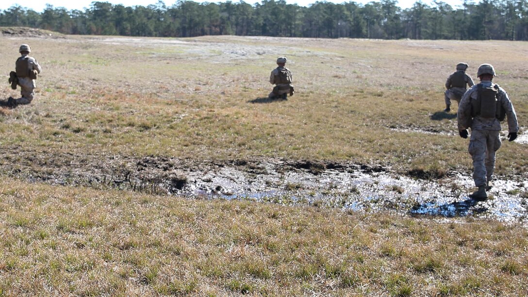 Marines with Easy Company, 2nd Battalion, 2nd Marine Regiment, utilize the buddy rush method to travel across a field using micro-terrain, such as small depressions or mounds, for cover and concealment, during a squad training exercise aboard Camp Lejeune, N.C., March 18, 2015. The training was designed to assist infantry squads by improving their ability to communicate and maneuver.