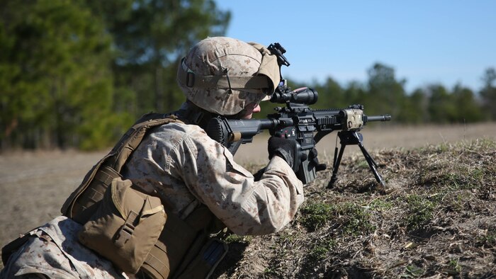 Lance Cpl. Christopher Bond, a rifleman with Easy Company, 2nd Battalion, 2nd Marine Regiment, takes aim at practice targets during a squad-training exercise aboard Camp Lejeune, N.C., March 18, 2015. The training was designed to assist infantry squads by improving their ability to communicate and maneuver. 