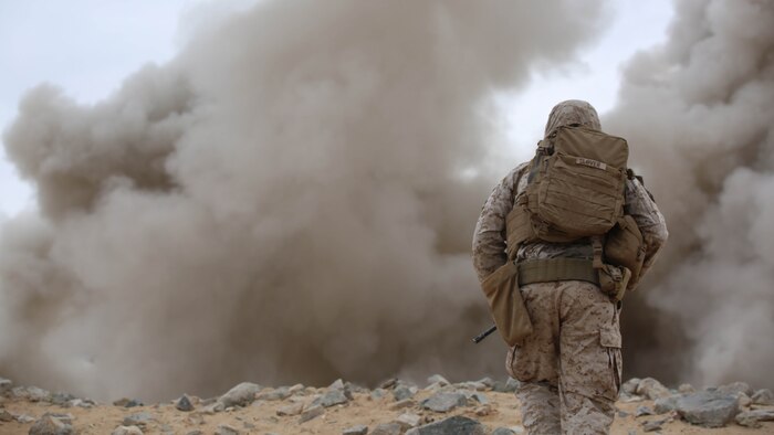 Sgt. Brenton A. Slover, squad leader, Engineer Platoon, Headquarters and Service Company, Ground Combat Element Integrated Task Force, observes the detonation of M1A2 Bangalores during a Marine Corps Operational Test and Evaluation Activity assessment at Range 107, Marine Corps Air Ground Combat Center Twentynine Palms, California, March 22, 2015. From October 2014 to July 2015, the GCEITF will conduct individual and collective level skills training in designated ground combat arms occupational specialties in order to facilitate the standards-based assessment of the physical performance of Marines in a simulated operating environment performing specific ground combat arms tasks. 