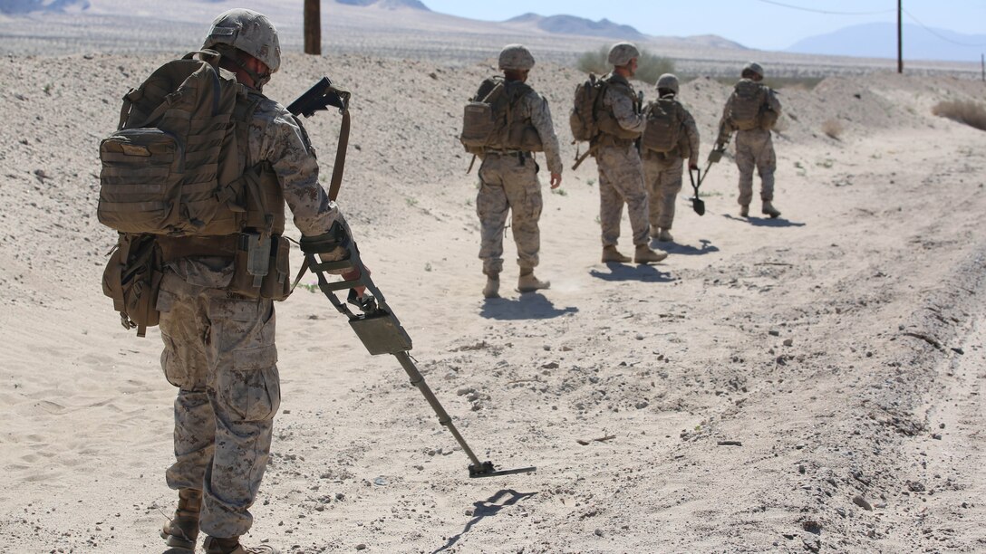 Marines with Engineer Platoon, Headquarters and Service Company, Ground Combat Element Integrated Task Force, sweep for mines during a Marine Corps Operational Test and Evaluation Activity assessment at Range 110, Marine Corps Air Ground Combat Center Twentynine Palms, California, March 23, 2015. From October 2014 to July 2015, the GCEITF will conduct individual and collective level skills training in designated ground combat arms occupational specialties in order to facilitate the standards-based assessment of the physical performance of Marines in a simulated operating environment performing specific ground combat arms tasks. 