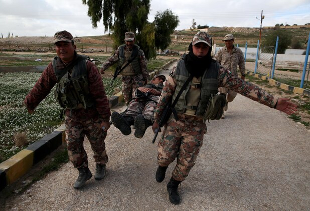 U.S. Navy Seaman Jeremy Hernandez, a corpsman with Company G, 2nd Battalion, 7th Marine Regiment, Special Purpose Marine Air Ground Task Force – Crisis Response – Central Command, supervises a group of Jordanian soldiers as they carry a simulated casualty on a stretcher in the U.S. Central Command area of operations, Feb. 8, 2015. U.S. Marines and sailors guided Jordanian soldiers through four stations where they learned and practiced various combat life saver skills. (U.S. Marine Corps photo by Cpl. Carson A. Gramley/Released)