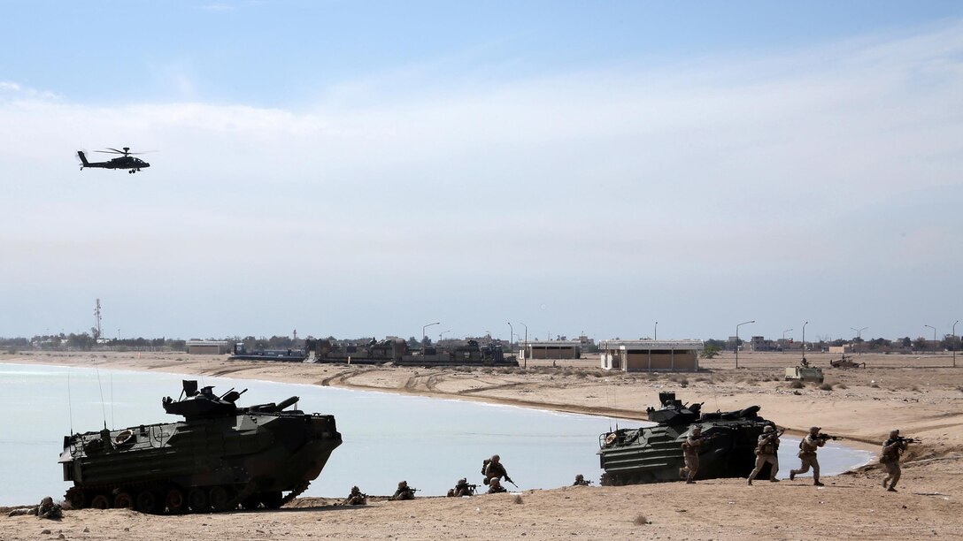 Marines with Kilo Company, Battalion Landing Team 3rd Battalion, 6th Marine Regiment, 24th Marine Expeditionary Unit, prepare to assault a simulated objective while escorted by a Kuwaiti AH-64D Apache helicopter during Exercise Eagle Resolve 2015 at Failaka Island, Kuwait, March 24, 2015. Eagle Resolve is the premiere Arabian Peninsula/gulf region exercise among the United States, Gulf Cooperation Council nations and international partners. It serves to address regional challenges associated with asymmetric/unconventional warfare in a multi-national environment. 