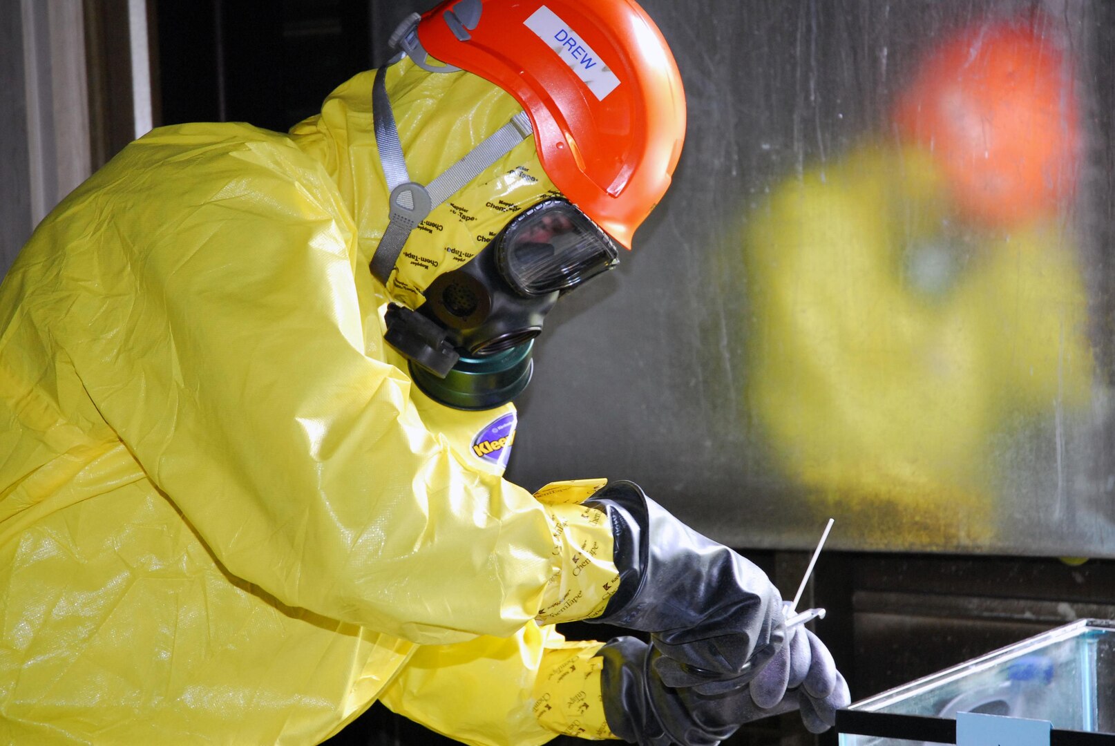 A member of the Alaska National Guard 103rd Civil Support Team collects a sample during a training exercise. The 103rd Civil Support Team mission is to assess hazards, advise civil authorities, and facilitate military support during emergencies and incidents of suspected weapons of mass destruction.