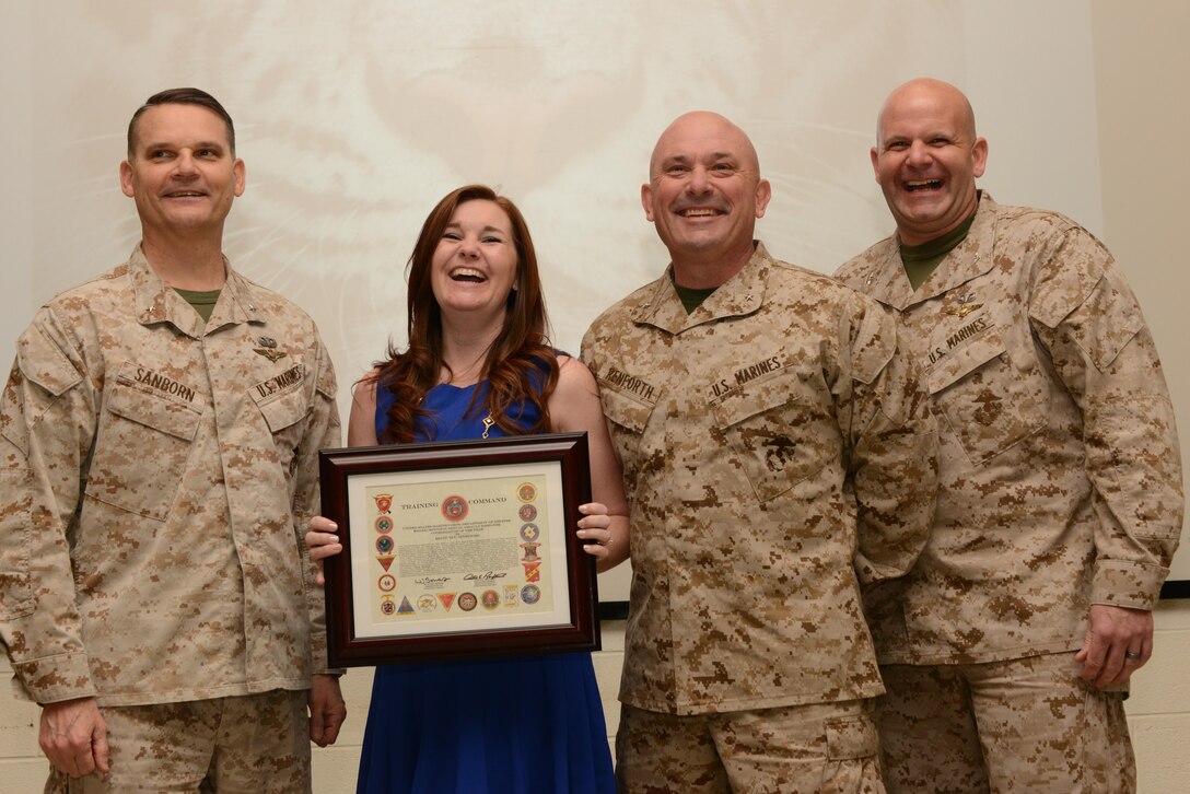 Brigadier Gen. Austin Renforth presented Erinn Izykowski, command sexual assault response coordinator, Training Command, Training and Education Command, with the Marine Corps 2015 SARC of the Year award in a ceremony at Mitchell Hall, The Basic School on March 26. Her selection was announced in Marine Administrative Message 113/15, which was signed by Brig. Gen. Russell Sanborn, who was also in attendance.