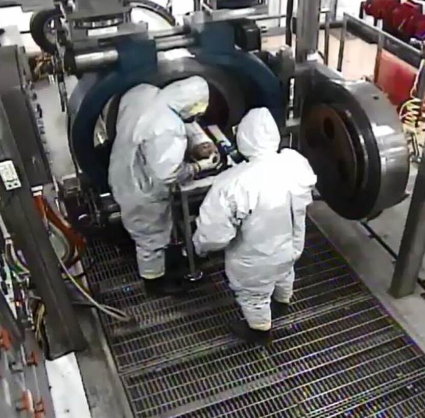 Pueblo Chemical Agent-Destruction Pilot Plant Explosive Destruction System operators place a Department of Transportation bottle containing mustard agent in the Munitions Holder for destruction March 18. After safe detonation, the bottle, which will be a metal fragment, is removed from the vessel.