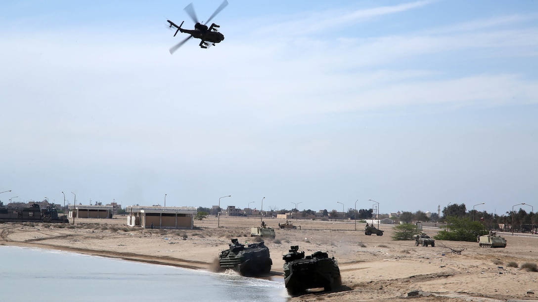 U.S. Marine Amphibious Assault Vehicles from Kilo Company, Battalion Landing Team 3rd Battalion, 6th Marine Regiment, 24th Marine Expeditionary Unit, move to their objective while being escorted by a Kuwaiti AH-64D Apache helicopter during a simulated amphibious assault as part of Exercise Eagle Resolve 2015 at Failaka Island, Kuwait, March 24, 2015. 
Eagle Resolve is the premiere Arabian Peninsula/gulf region exercise among the United States, Gulf Cooperation Council nations, and international partners. It serves to address regional challenges associated with asymmetric/unconventional warfare in a multi-national environment.