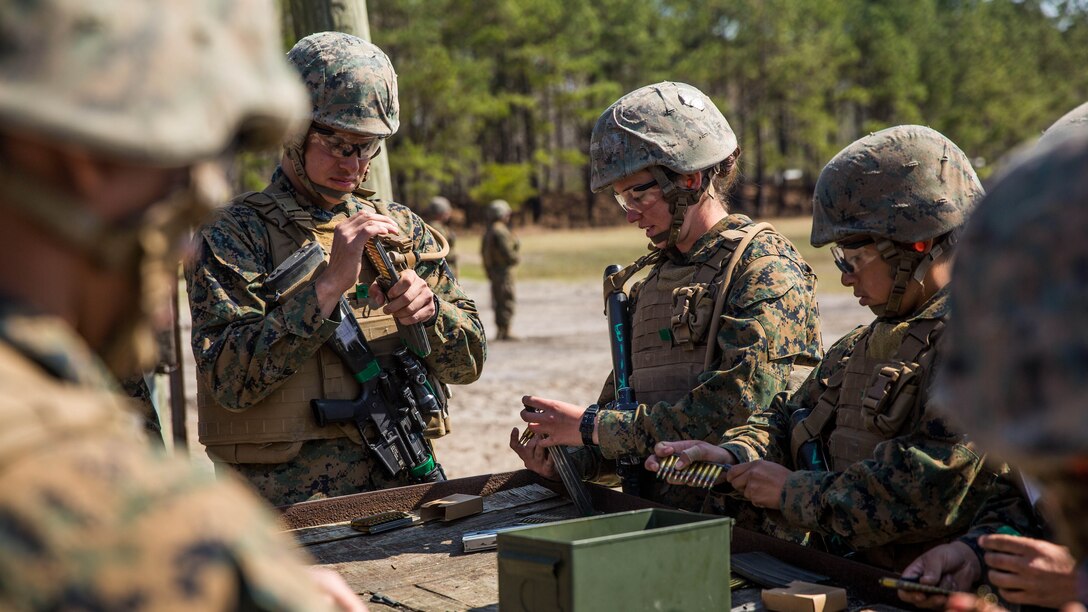 Students with Kilo Company, Marine Combat Training Battalion, load magazines with ammunition prior to starting a fire and movement range aboard Camp Lejeune, N.C., March 24, 2015. During the range, Marines were issued 30 rounds of ammunition and advanced across a field in teams, while engaging targets from unknown distances, providing suppressive fire for their peers. 