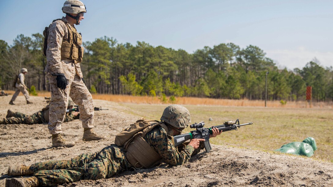 A student with Kilo Company, Marine Combat Training Battalion awaits an order to sight in and fire his weapon at targets from an unknown distance during a fire and movement range aboard Camp Lejeune, N.C., March 24, 2015. The fire and movement range put to practice the basic rifleman skills Marines acquire at boot camp and adds a component of shooting and moving while maintaining communication with team members. 