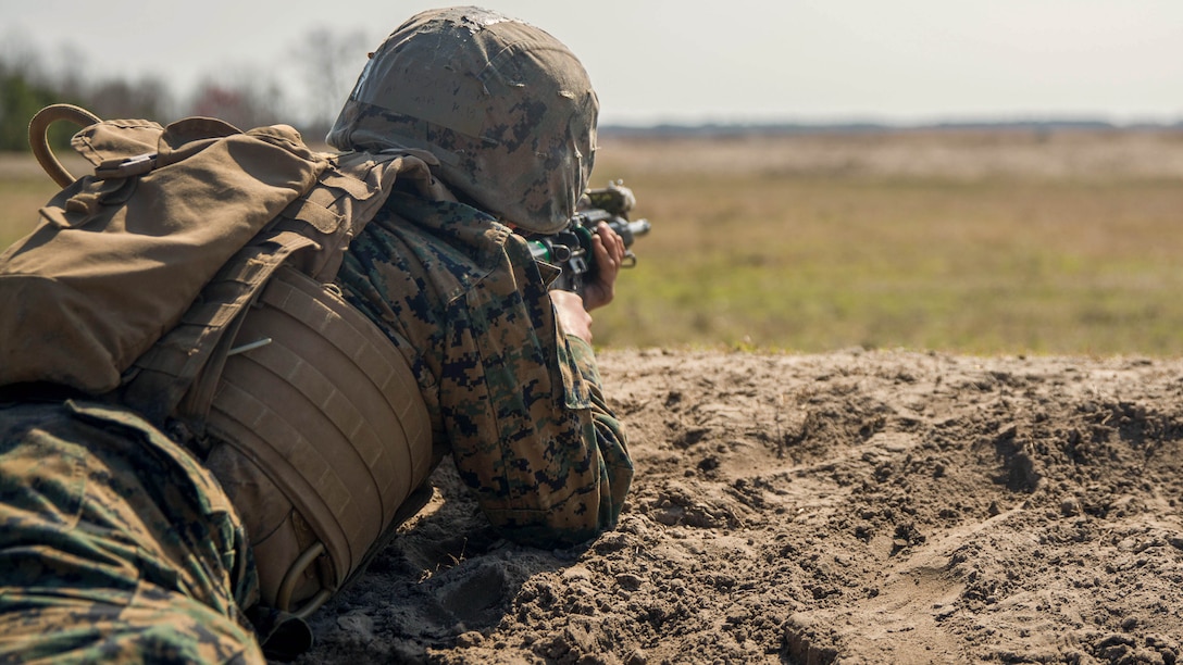A student with Kilo Company, Marine Combat Training Battalion aims her M16-A4 service rifle at targets from an unknown distance during a fire and movement range aboard Camp Lejeune, N.C., March 24, 2015. The fire and movement range was the first time students were equipped with live ammunition and allowed to move across a field as a team, engaging targets and providing suppressive fire for their peers. 