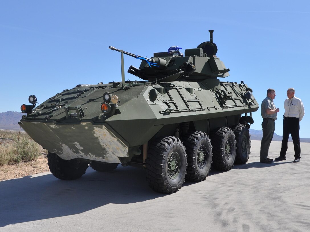 James Oman, director of Senior Service College Fellowship Program at Defense Acquisition University and retired colonel with the U.S. Army, discusses mission and production capabilities with Ed Shimko, plant manager of Production Plant Barstow, aboard Marine Corps Logistics Base Barstow, Calif., March 25.  During the tour, PPB conducted a demonstration of the test track using a light armored vehicle and an amphibious assault vehicle. 