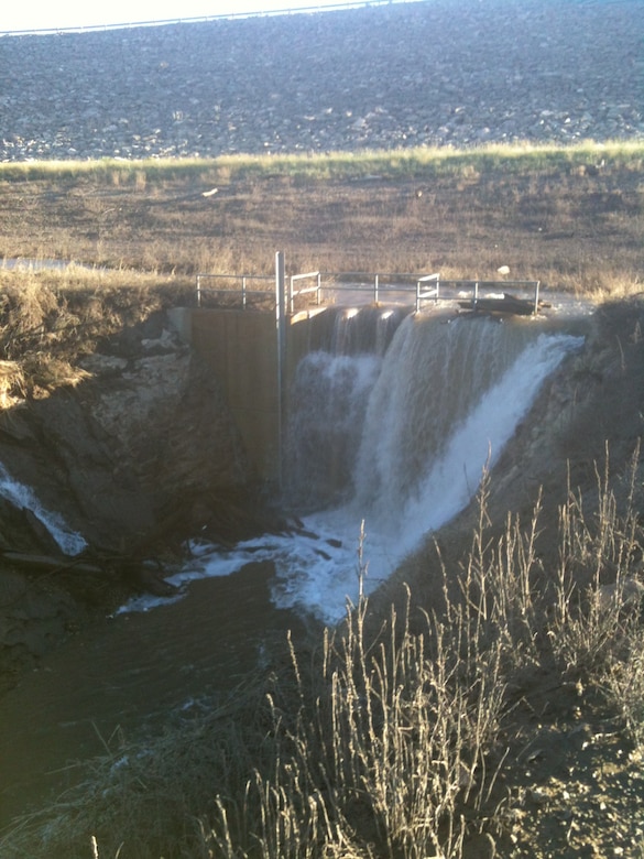 ROSWELL, N.M. -- Water flows where it shouldn’t – over the trash rack and intake structure at Two River’s Diamond A Dam, after a heavy rain event in September 2013. 