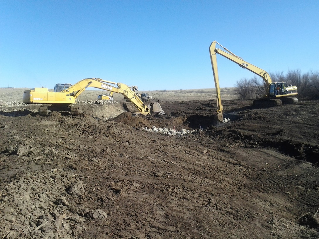 ROSWELL, N.M. – Construction equipment and crew from Reclamation work on a new flood channel at the District’s Two River’s Diamond A Dam, Feb. 17, 2015.