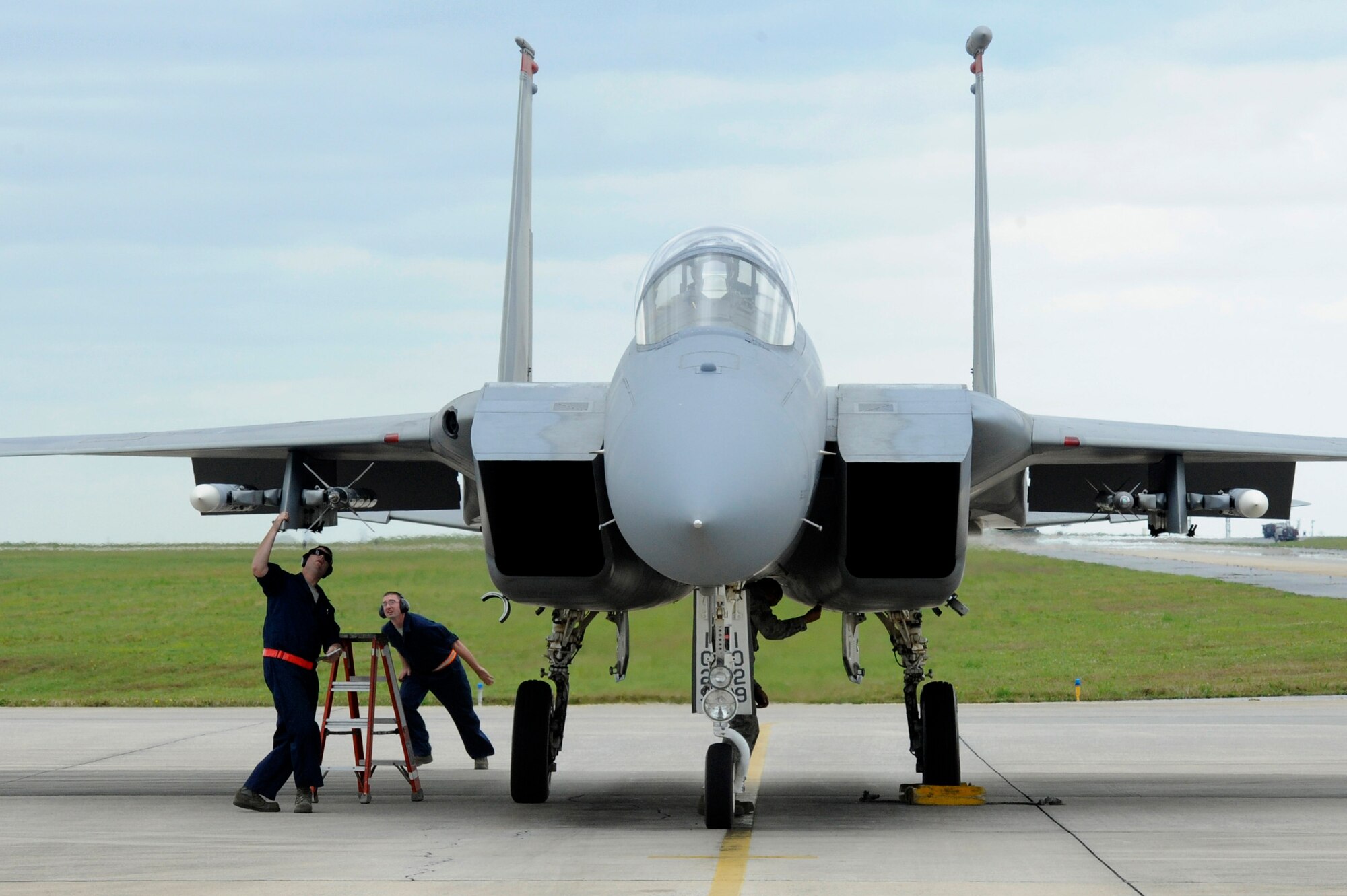 Airmen from the 67th Aircraft Maintenance Unit rush to complete final inspections on F-15C Eagles before they take off during a sortie surge on Kadena Air Base, Japan, March 25, 2015. A surge is a scheduled event where a unit generates a higher number of sorties than usual. The surge allows the unit to get ahead of flying goals and tests their maximum production capability. (U.S. Air Force photo by Staff Sgt. Marcus Morris)