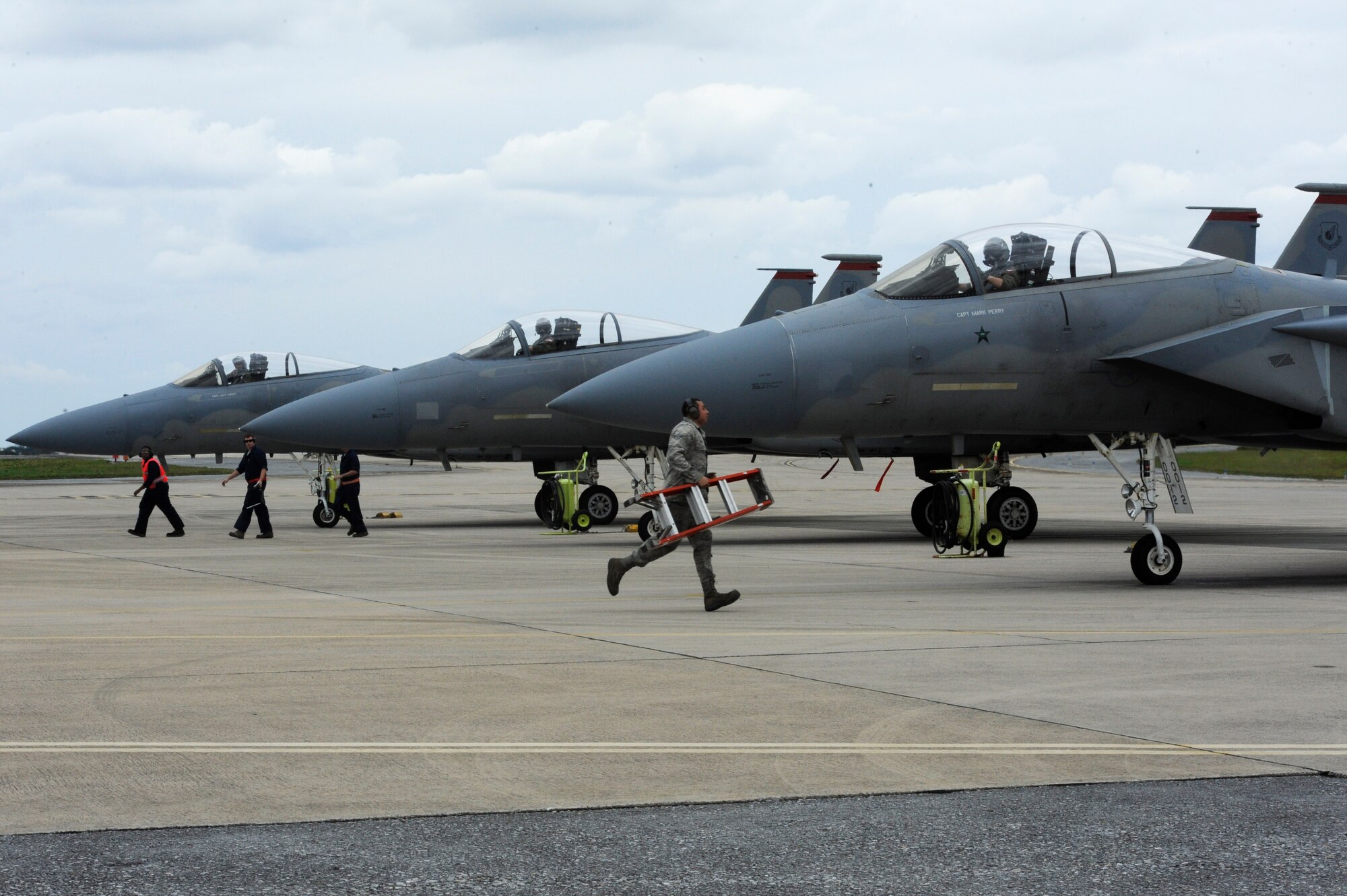 Airmen from the 67th Aircraft Maintenance Unit rush to complete final inspections on F-15C Eagles before take off during a sortie surge on Kadena Air Base, Japan, March 25, 2015. The 67th FS broke a Kadena Air Base record March 26, 2015, by flying 278 sorties in four days, beating the previous record held by the 44th Fighter Squadron of 244. (U.S. Air Force photo by Staff Sgt. Marcus Morris)