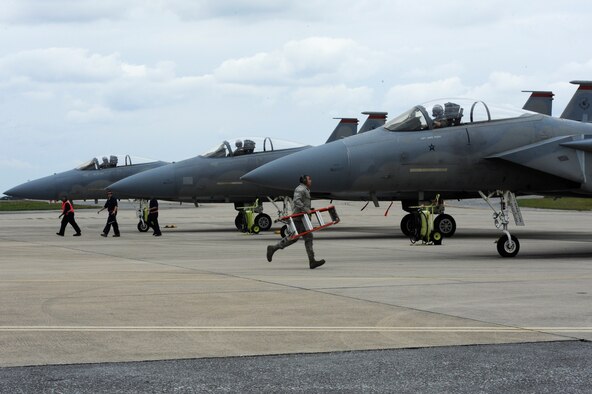 Airmen from the 67th Aircraft Maintenance Unit rush to complete final inspections on F-15C Eagles before take off during a sortie surge on Kadena Air Base, Japan, March 25, 2015. The 67th FS broke a Kadena Air Base record March 26, 2015, by flying 278 sorties in four days, beating the previous record held by the 44th Fighter Squadron of 244. (U.S. Air Force photo by Staff Sgt. Marcus Morris)