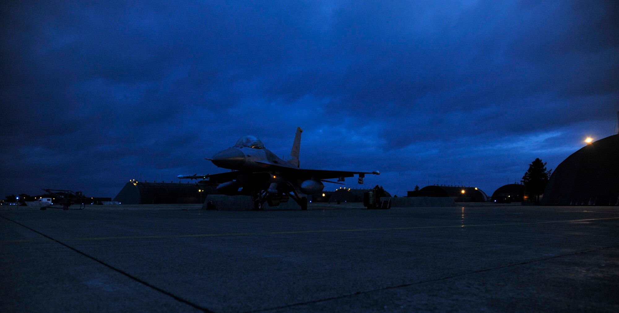 An F-16 Fighting Falcon idles in preparation for a night flight at Misawa Air Base, Japan, Mar. 25, 2015. While the jet idles for inspection before taxiing, the pilot and their crew chief perform engine and thruster checks, ensuring the jet’s ability to safely and effectively take off and begin its mission. (U.S. Air Force photo by Airman 1st Class Patrick S. Ciccarone/Released)