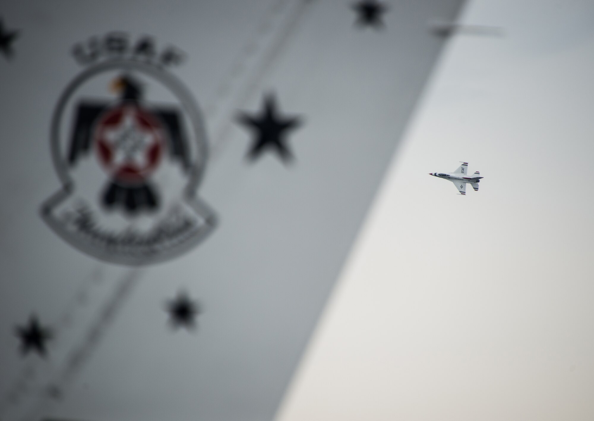 A U.S. Air Force Thunderbird circles Keesler Air Force Base, Miss., March 26, 2015, in advance of the 2015 Keesler Air Show/Open House March 28-29.  The Thunderbirds are making their first air show appearance at Keesler since 2009.  The event is Keesler’s first air show in 4 years.  (U.S. Air Force photo by Marie Floyd)