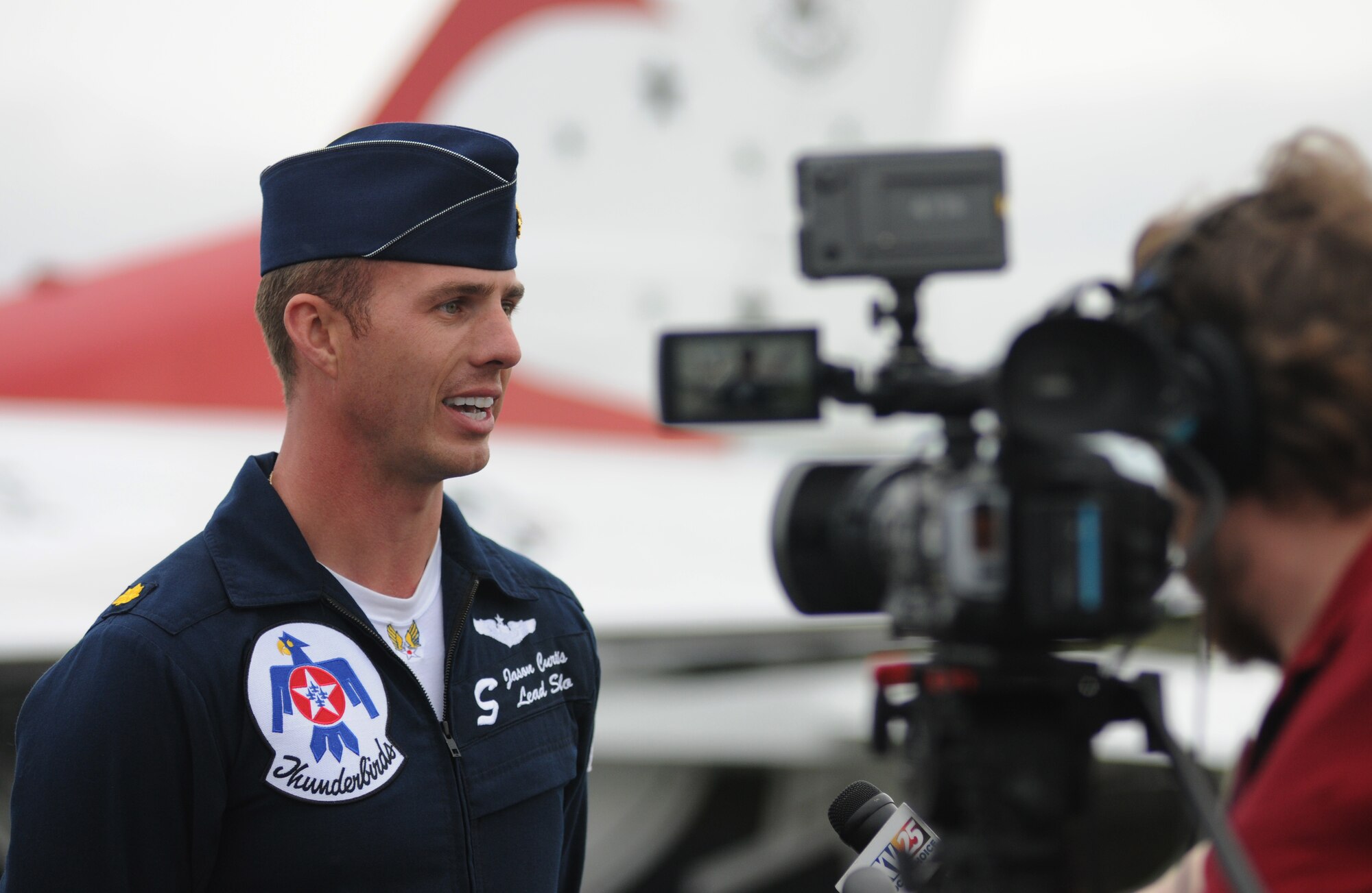 Maj. Jason Curtis, U.S. Air Force Thunderbirds lead solo number 5, is interviewed by local media in advance of the 2015 Keesler Air Show/Open House March 26, 2015, at Keesler Air Force Base, Miss.  The Thunderbirds are making their first air show appearance at Keesler since 2009.  The event is Keesler’s first air show in 4 years.  (U.S. Air Force photo by Kemberly Groue)