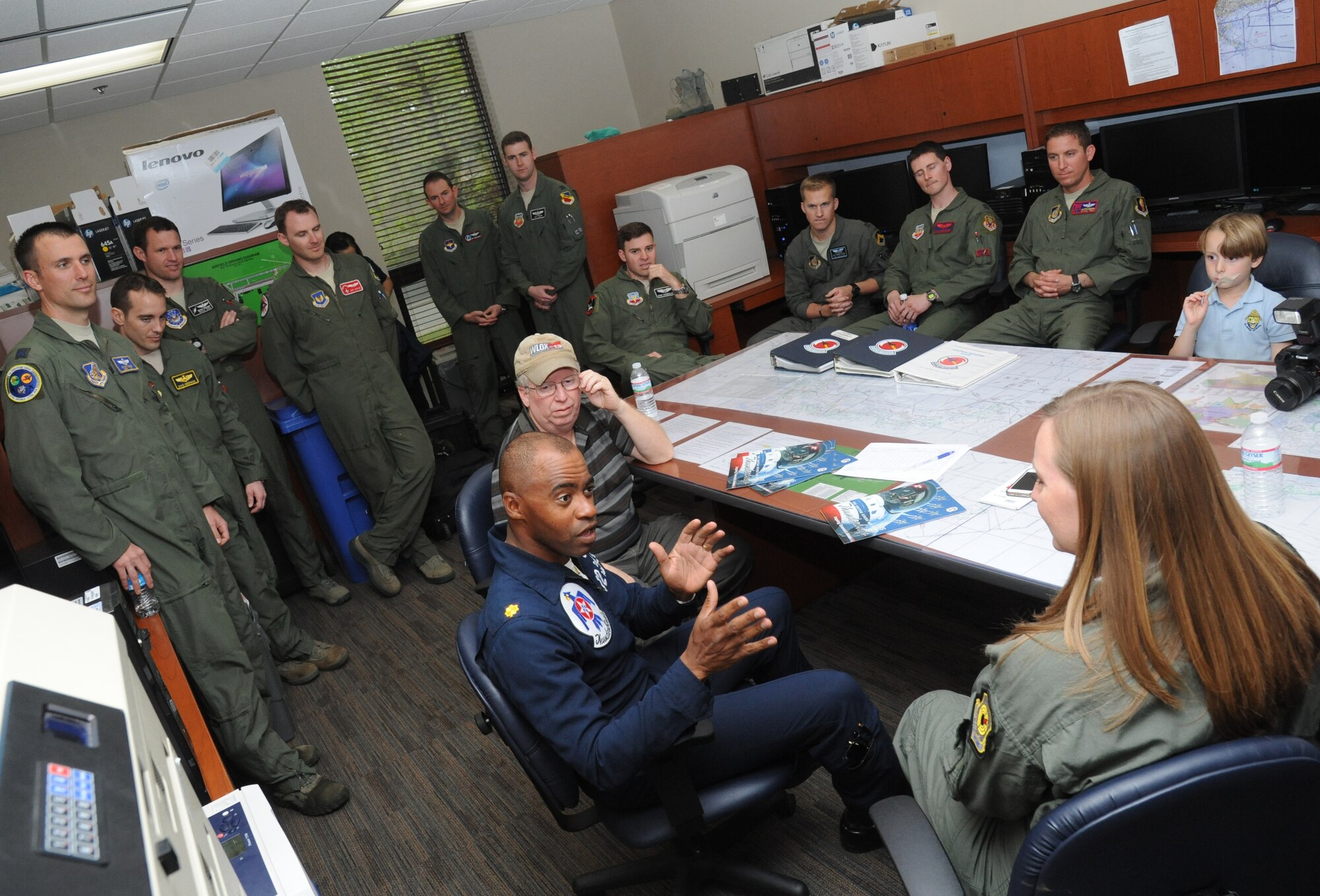 Maj. Darrick Lee, U.S. Air Force Thunderbirds public affairs officer number 12, briefs Meggan Gray, WLOX anchor, and Rodney Billingsby, WLOX camera operator, during flight training March 26, 2015, at Keesler Air Force Base, Miss.  The training was to prepare Gray for a media flight with the U.S. Air Force Thunderbirds March 27.  The Thunderbirds are headlining Keesler’s 2015 Air Show/Open House to be held March 28-29.  (U.S. Air Force photo by Kemberly Groue)