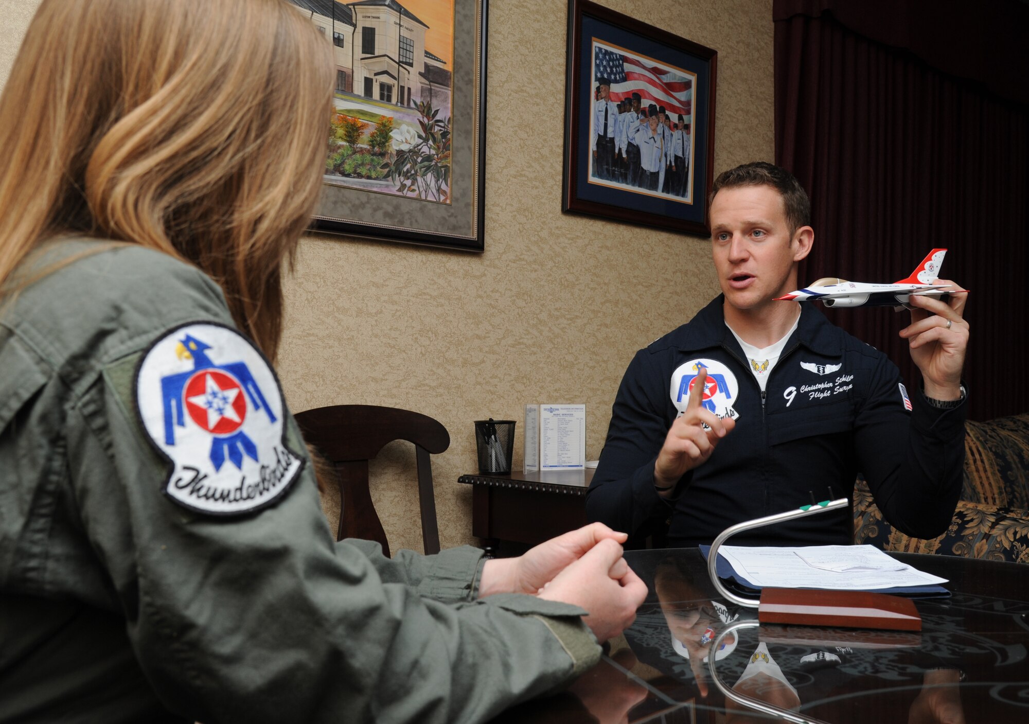 Meggan Gray, WLOX anchor, receives flight training from Capt. Christopher Scheibler, U.S. Air Force Thunderbirds flight surgeon number 9, March 26, 2015, at Keesler Air Force Base, Miss., in preparation for a media flight with the Thunderbirds March 27.  The Thunderbirds are headlining Keesler’s 2015 Air Show/Open House to be held March 28-29.  (U.S. Air Force photo by Kemberly Groue)