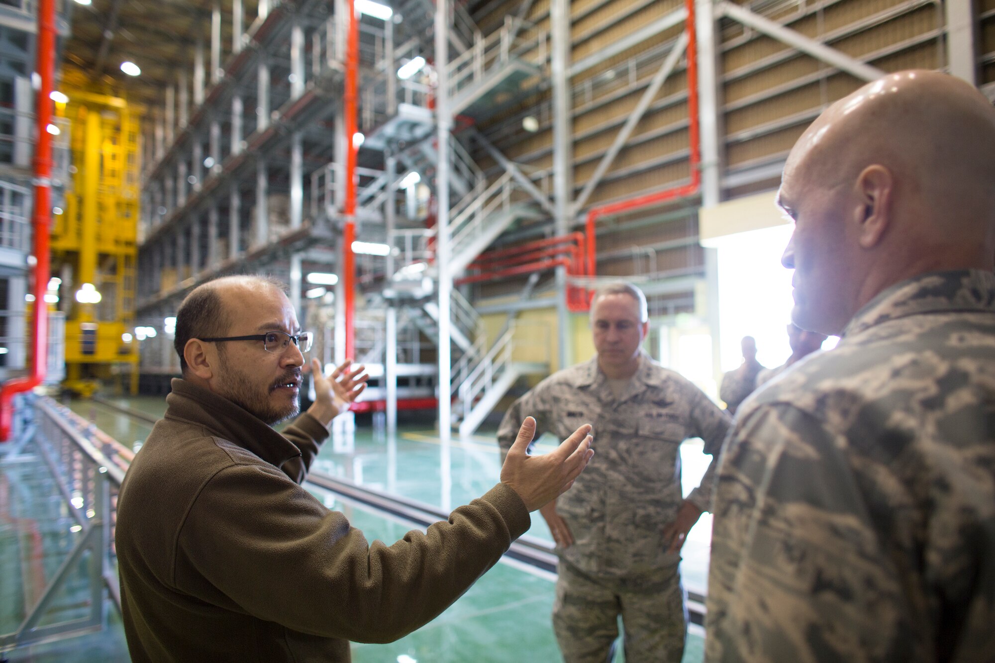 (Left to right) Ernie Weber, 730th Air Mobility Squadron air terminal manager, briefs Maj. Gen. Frederick Martin, U.S. Air Force Expeditionary Center commander, and Lt. Gen. Carlton D. Everhart II, 18th Air Force commander in the WestPac Transportation Facility at Yokota Air Base, Japan, March 26, 2015. Weber  explained the mechanized material handling system in the facility. (U.S. Air Force photo by Osakabe Yasuo/Released)
