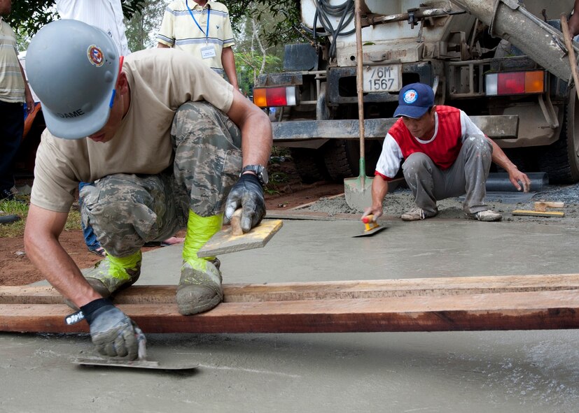 U.S. Air Force and Vietnam People's Army members smooth out concrete at Binh Thanh Dong primary school, Quang Ngai Province, Vietnam, during an engineering project, March 25, 2015. Operation Pacific Angel 15-3 is a total force, joint and combined humanitarian assistance operation led by the U.S. Pacific Air Forces. The operation promotes interoperability amongst U.S. military, host nation and multilateral military and civilian organizations. (U.S. Air Force photo by Staff Sgt. Tong Duong/ Released)