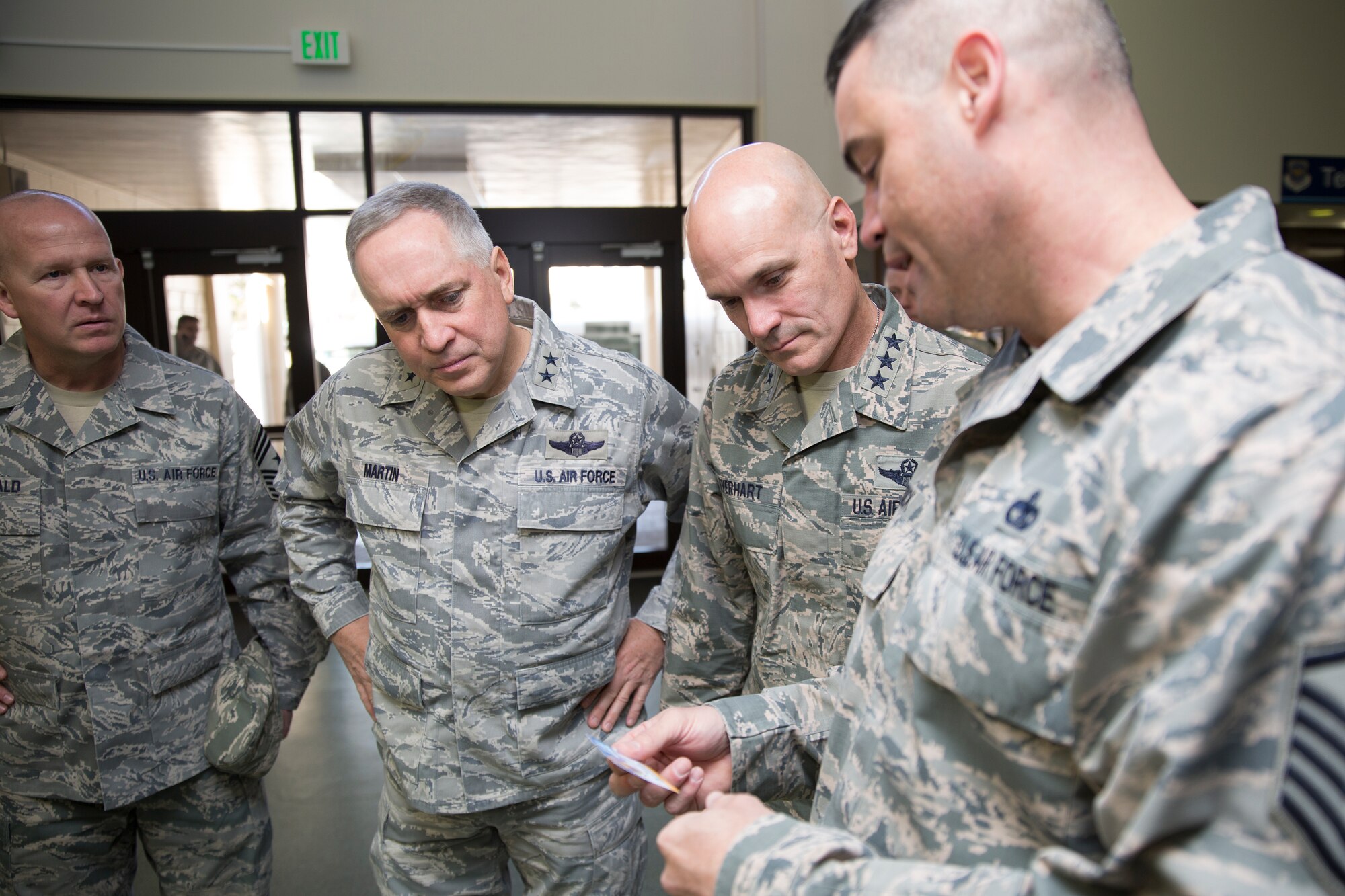 (Right to left) Master Sgt. David Burdick, 730th Air Mobility Squadron passenger terminal superintendent, briefs Lt. Gen. Carlton D. Everhart II, 18th Air Force commander, and Maj. Gen. Frederick Martin, U.S. Air Force Expeditionary Center commander, in the Yokota passenger terminal at Yokota Air Base, Japan, March 26, 2015. Burdick explained that the Yokota passenger terminal is the oldest passenger facility in the Pacific, but also the busiest with more than 100,000 passengers using the facility annually. (U.S. Air Force photo by Osakabe Yasuo/Released)