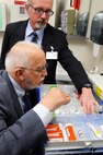 Col. (Ret) Frederick Schaefer, (back), and Dr. Paul Allen, inspect a medical cabinet during an Accreditation Association of Ambulatory Health Care inspection, Mar. 24, 2015, at Malmstrom Air Force Base, Mont.  The AAAHC three-day inspection occurs every three years and covers virtually every aspect of the hospital system, from patient treatment to infectious disease control.  (U.S. Air Force photo/Chris Willis)