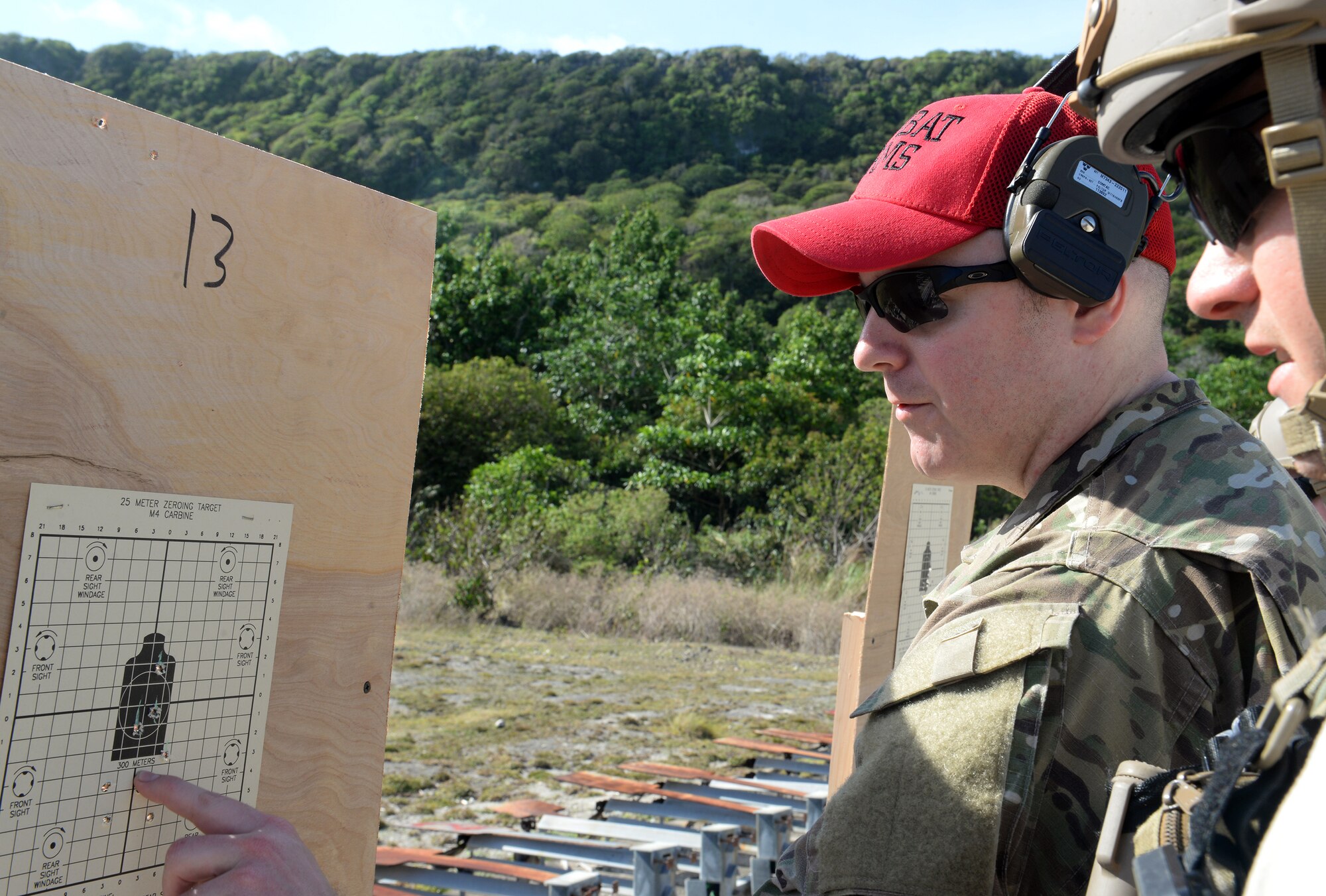 Tech. Sgt. Travis Justis, combat arms instructor from the Washington Air National Guard’s 194th Security Forces Flight, gives directions to zero a weapon’s sight during combat arms training and maintenance for Exercise Husky Machete March 11, 2015, at Andersen Air Force Base, Guam. The Airmen utilized many of Andersen’s resources, including the firing range for small arms training, facilities at Andersen South, Northwest Field and Tarague Beach for field training. (U.S. Air Force photo by Senior Airman Amanda Morris/Released)