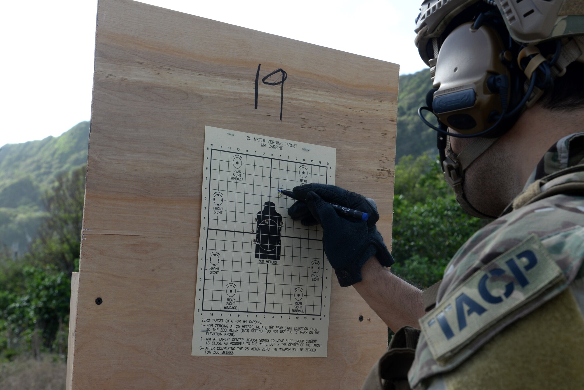Staff Sgt. Mannie Ibara, a Tactical Air Control Party specialist from the Washington Air National Guard’s 116th Air Support Operations Squadron, marks on a target during combat arms training and maintenance for Exercise Husky Machete March 11, 2015, at Andersen Air Force Base, Guam. The Airmen utilized many of Andersen’s resources, including the firing range for small arms training, facilities at Andersen South, Northwest Field and Tarague Beach for field training. (U.S. Air Force photo by Senior Airman Amanda Morris/Released)